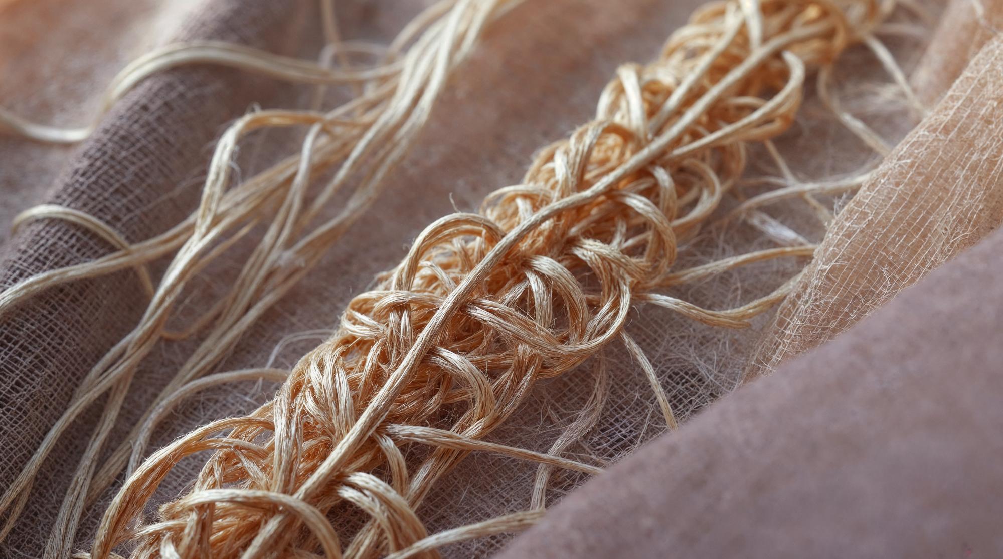 Close-up of metallic thread loops on linen