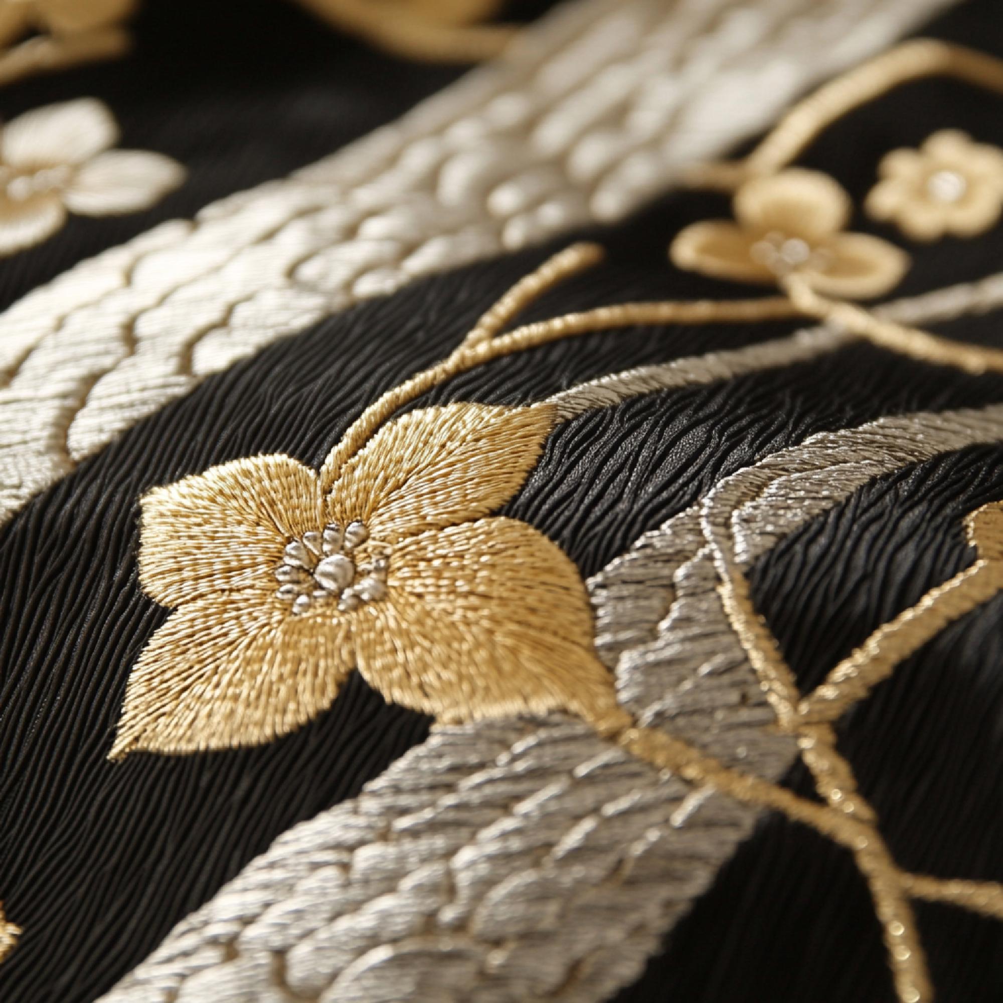 Intricate gold-thread floral embroidery on dark fabric
